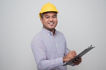 Asian manager civil engineer in uniform hard hat holding clipboard working in studio isolated white background.