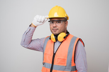 Young asian civil engineer in uniform earmuff helmet safety glasses standing in studio isolated white background. Mechanic home service concept.