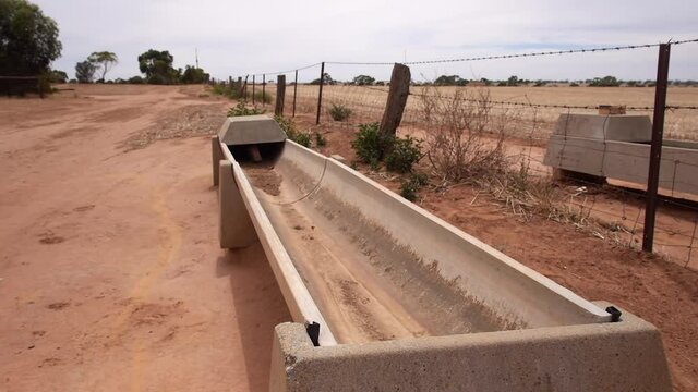 Dry water trough on a farm during drought in Australia closeup