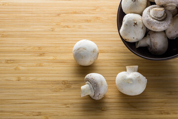 Fresh mushrooms champignon on a wooden board.