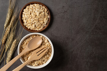 Oat flakes in bowl top view. Concept healthy eating, dieting and vegetarian food.