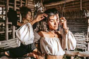 Two beautiful young stylish fashion models having fun outdoors