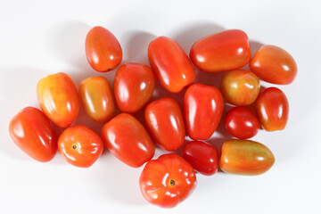 Fresh ripe small shiny red tomato on white background