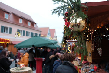 Christmas market in Germany. Christmas holidays in Germany.People at the Christmas market  on a traditional German style fachwerk houses background.Christmas and New Year in Europe