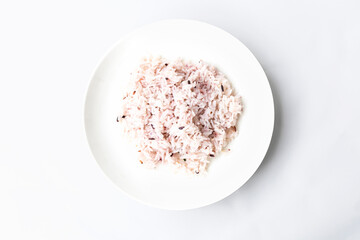 Plain rice on a white plate on a white background. Top view flat lay of business restaurant and food menu
