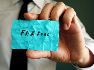Business concept meaning FHA Loan with sign on the page.
