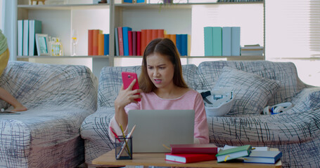 Seriously Young mother while working at home with two daughters
