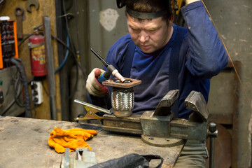 Close-up portrait of a welder in the workplace