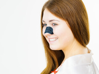 Woman with nose mask pore strips