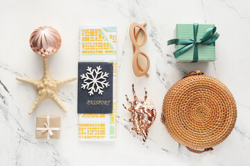 Composition with Christmas decor, passport, map and beach accessories on white background