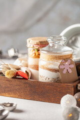 Ingredients for Christmas cookies in a jar on a festive background. Eco friendly concept