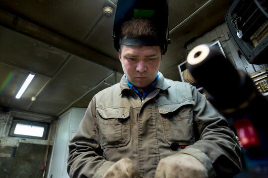 Close-up portrait of a welder in the workplace