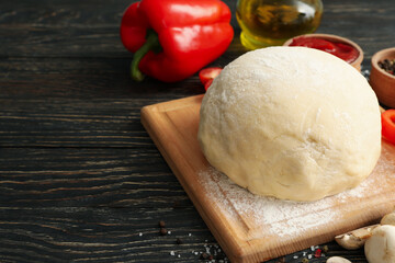 Ingredients for cooking pizza on wooden background