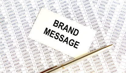 Obraz premium BRAND MESSAGE text, pen. Reports serve as the background.
