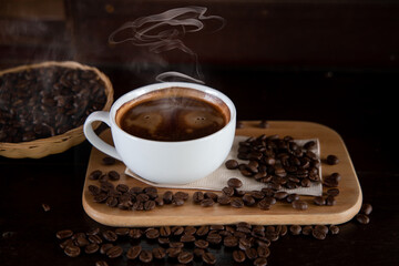 Hot coffee cups and coffee beans are placed on a small basket.