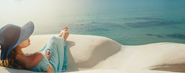 Banner Young woman with hat on the white rocks on the beach Sicily © Gita
