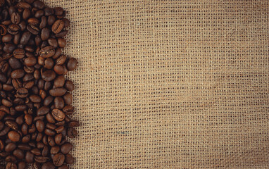 Roasted coffee beans on burlap. Background for coffee shops and store websites