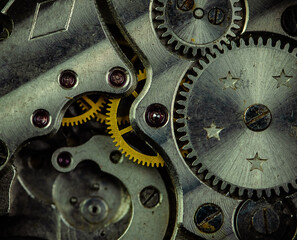 Vintage watch movement close - up. Selective focus on elements, macro photography. Background in steampunk style. Metallic grunge texture. Easy image tinting