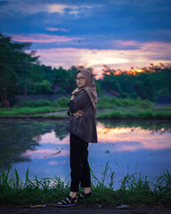 Muslim women are posing and stylish against the backdrop of beautiful scenery and sunset.