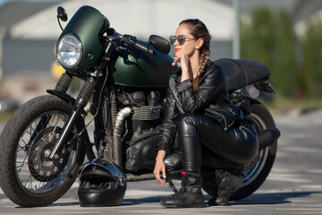 Naklejka na ściany i meble girl in black with a motorcycle