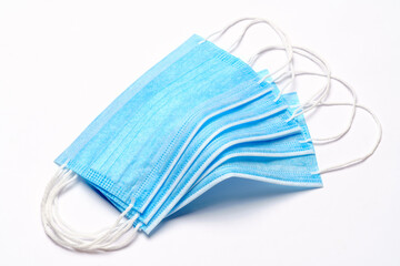 coronavirus COVID-19 pandemic concept - stack of antiviral surgical protective medical mask for protection against corona virus