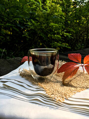up of coffee with autumn leaves