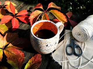 up of coffee with autumn leaves