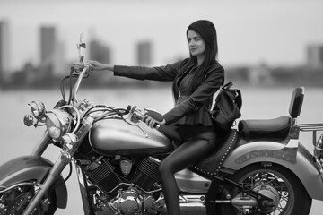 Obraz na płótnie Canvas girl in black with a motorcycle