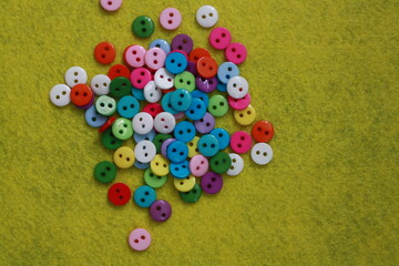 multicolored buttons on a yellow background