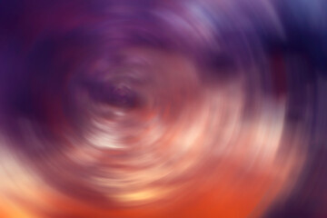 Abstract colored background. Multicolor background. Blue, purple, orange color. The colors are swirling in a circle.
