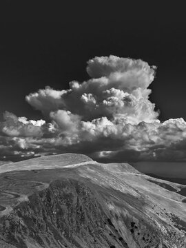 sureal storm cloud over transalpina mountain road, romania, black and white photo