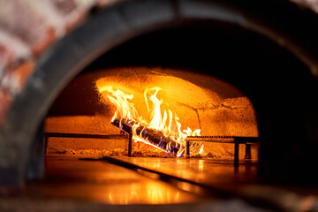 Traditional wood oven in Naples restaurant, Italy. Original neapolitan pizza. Red hot coal. Baked tasty pizza