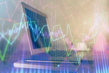 Stock market graph and table with computer background. Multi exposure. Concept of financial analysis.
