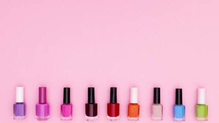 Black nail polish bottles change color on bottom of pink theme. Stop motion 
