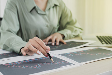 Trader businesswoman analyze stock graph and report, set targets for online forex trading market management success