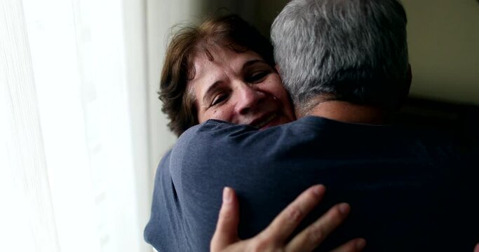 Senior wife hugging husband in tender loving moment
