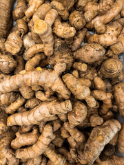 Turmeric is arranged for background design. Piles of herbs to create designs about agriculture, food, nature, & healthy living.