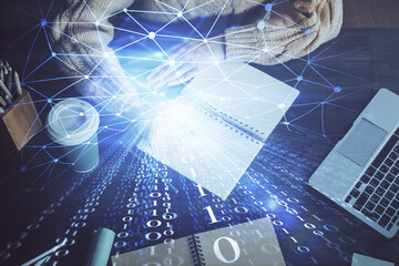 Double exposure of writing hands on background with data solution hologram on front. Technology concept. Close up