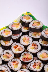 Top view of stack of Japanese sushi maki roll plate. Served in Japanese bar restaurant with chopstick