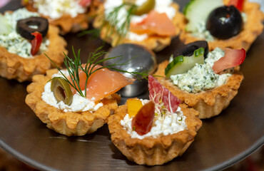 A variety of cold snacks on the table at parties, stuffed baskets with cheese and vegetables