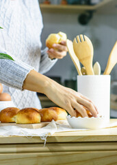 Fresh bun, kitchen utensils and eggs wooden background, homemade bakery presence of a human.
