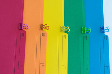Vibrant Coloured File Folders and Paperclips, Top View Background