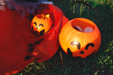 halloween candy baskets lie on the grass