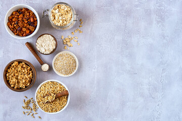 Oat products assortment in bowls. Granola, rolled oats, bran , flour and raw oat seeds . Top view