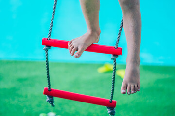 Shot Caucasian boy dirty legs toes foot calf knees sit on rope ladder down stairs outside playground Behavior, daycare summer, childhood care safety play, future direction growth education concept