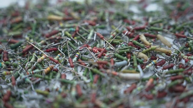 A scattering of various old radio parts transistor resistor diode.
