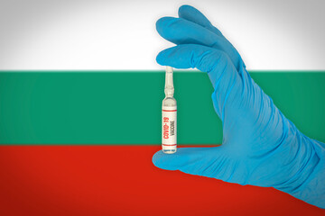 New coronavirus vaccine with the flag of Bulgaria in the background. Bulgaria medical research and vaccine development center. Doctor holding coronavirus vaccine in his hand.