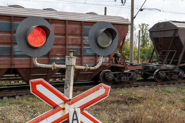 Railway traffic light, against the background of a moving train