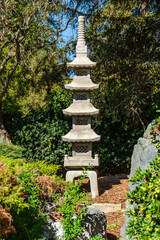 Japanese stone lantern in the form of a pagoda in the Japanese Friendship Garden.