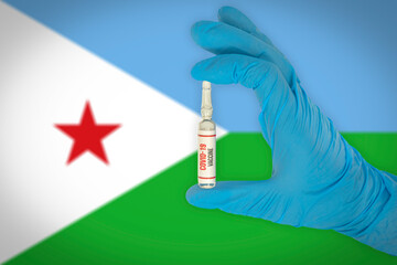 New coronavirus vaccine with the flag of Djibouti in the background. Djibouti medical research and vaccine development center. Doctor holding coronavirus vaccine in his hand.